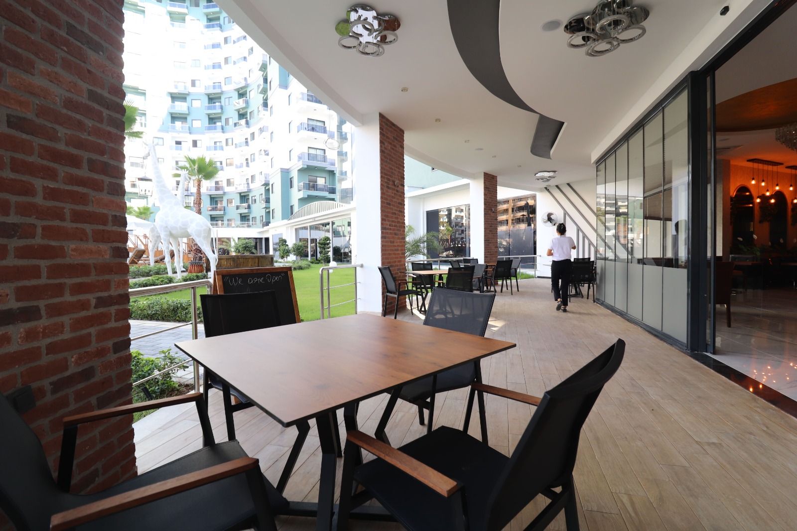 Restaurant with a wooden dining table and panoramic glazing in Mahmutlar