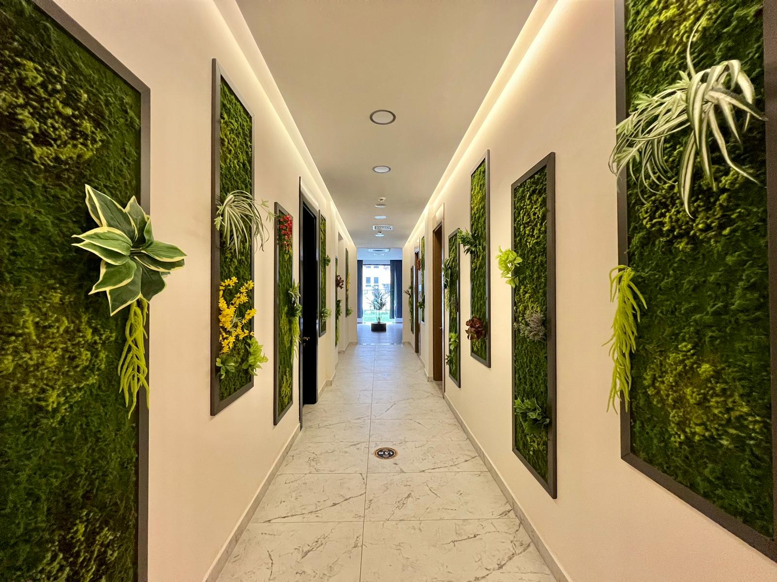 Bright corridor with marble flooring and green wall panels in a residence in Mahmutlar
