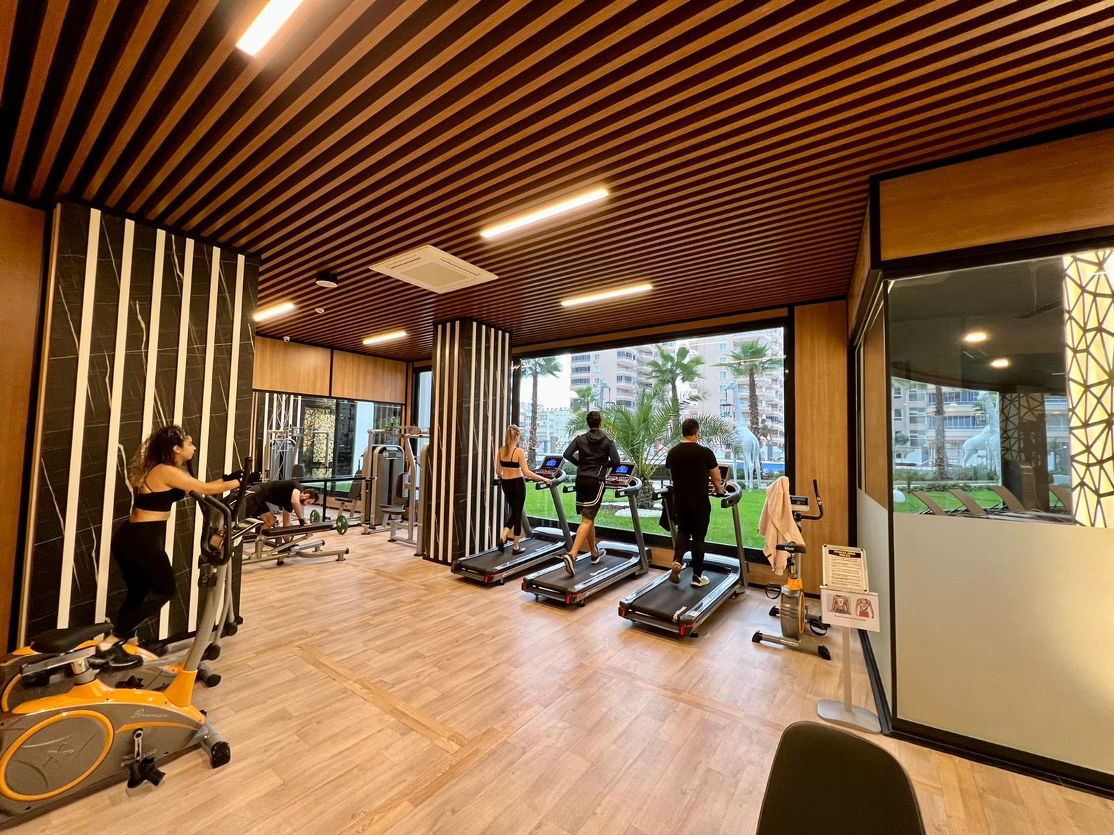 Gym with treadmills and panoramic windows for residents of apartments in the complex