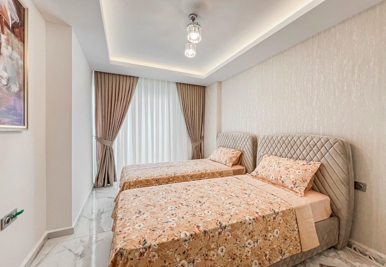 Bedroom with two single beds, panoramic window and light marble flooring