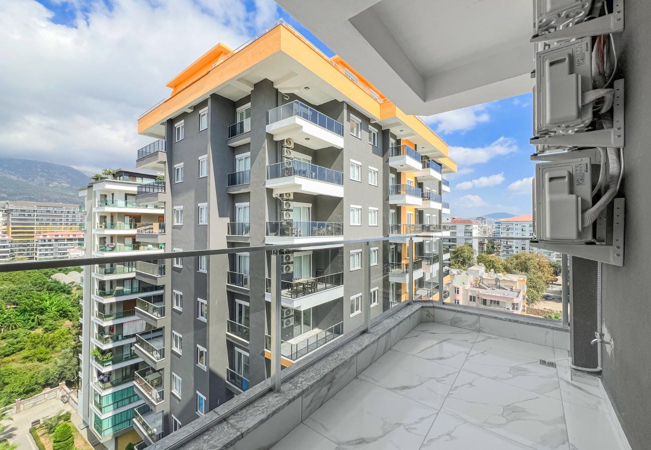 Balcony with transparent railing and mountain view in an apartment for sale in Turkey
