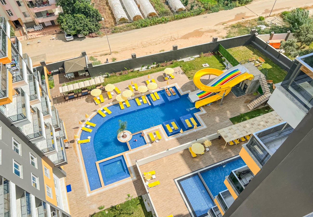 Outdoor pool with water slide and jacuzzis in a complex with apartments for sale in Mahmutlar