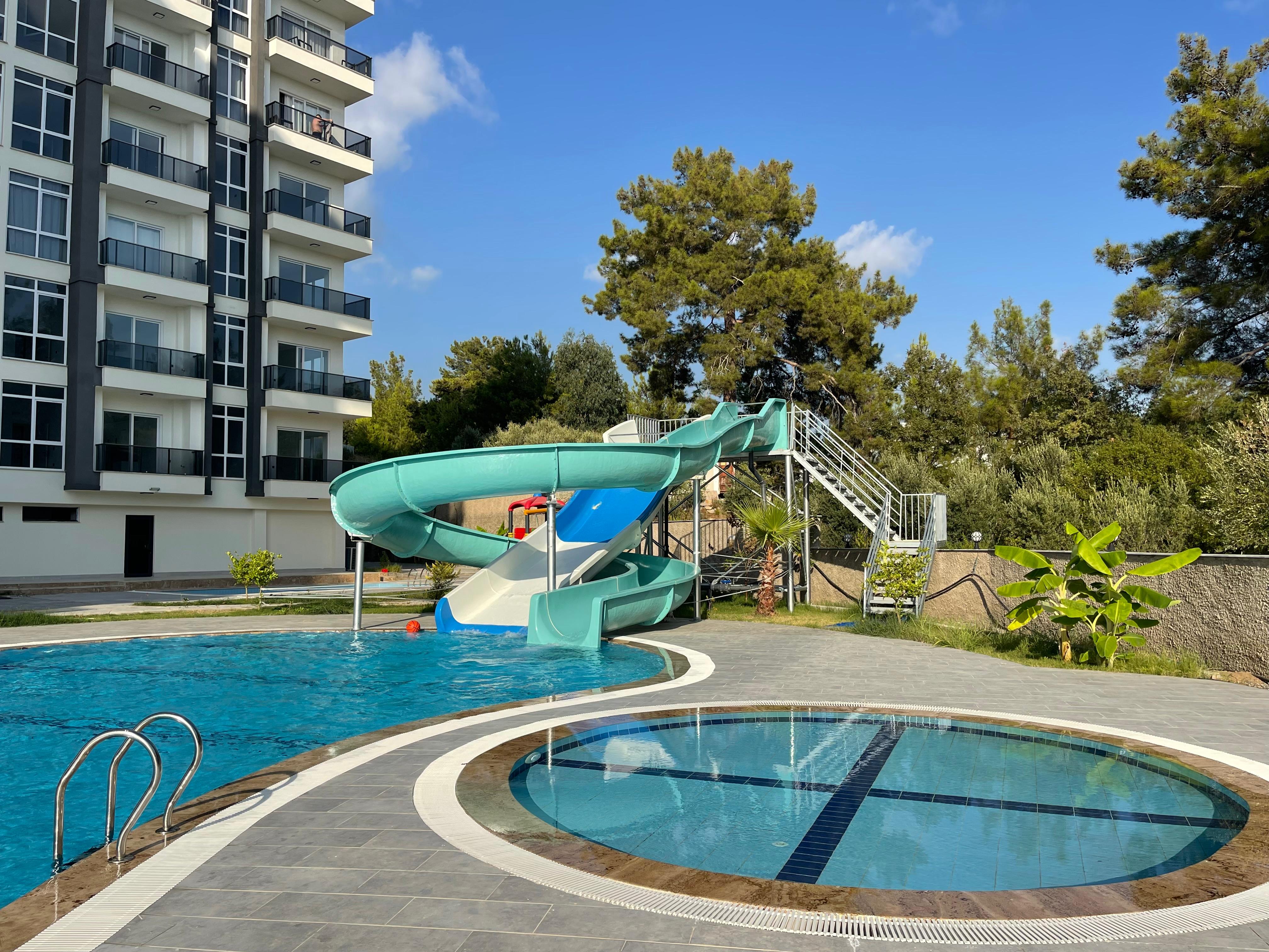 Water slide beside the outdoor pool in Avsallar where apartments are for sale