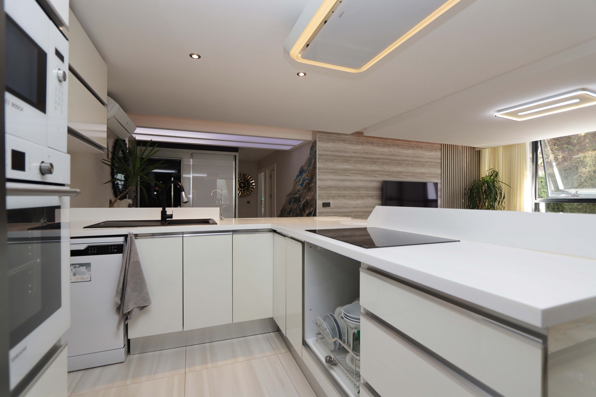 Kitchen-living room with white cabinetry, island and panoramic window