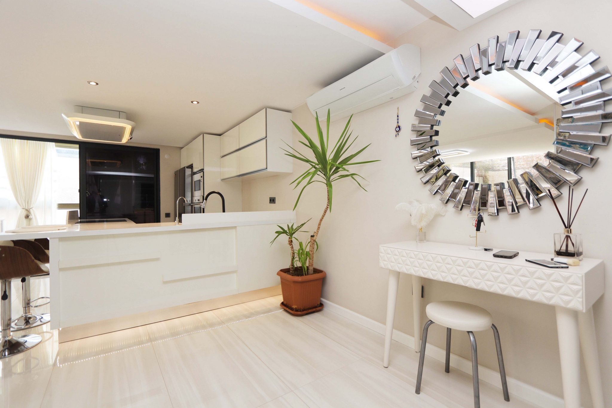 White island, dressing table and glass door in the kitchen-living room of a Kargicak flat in Turkey