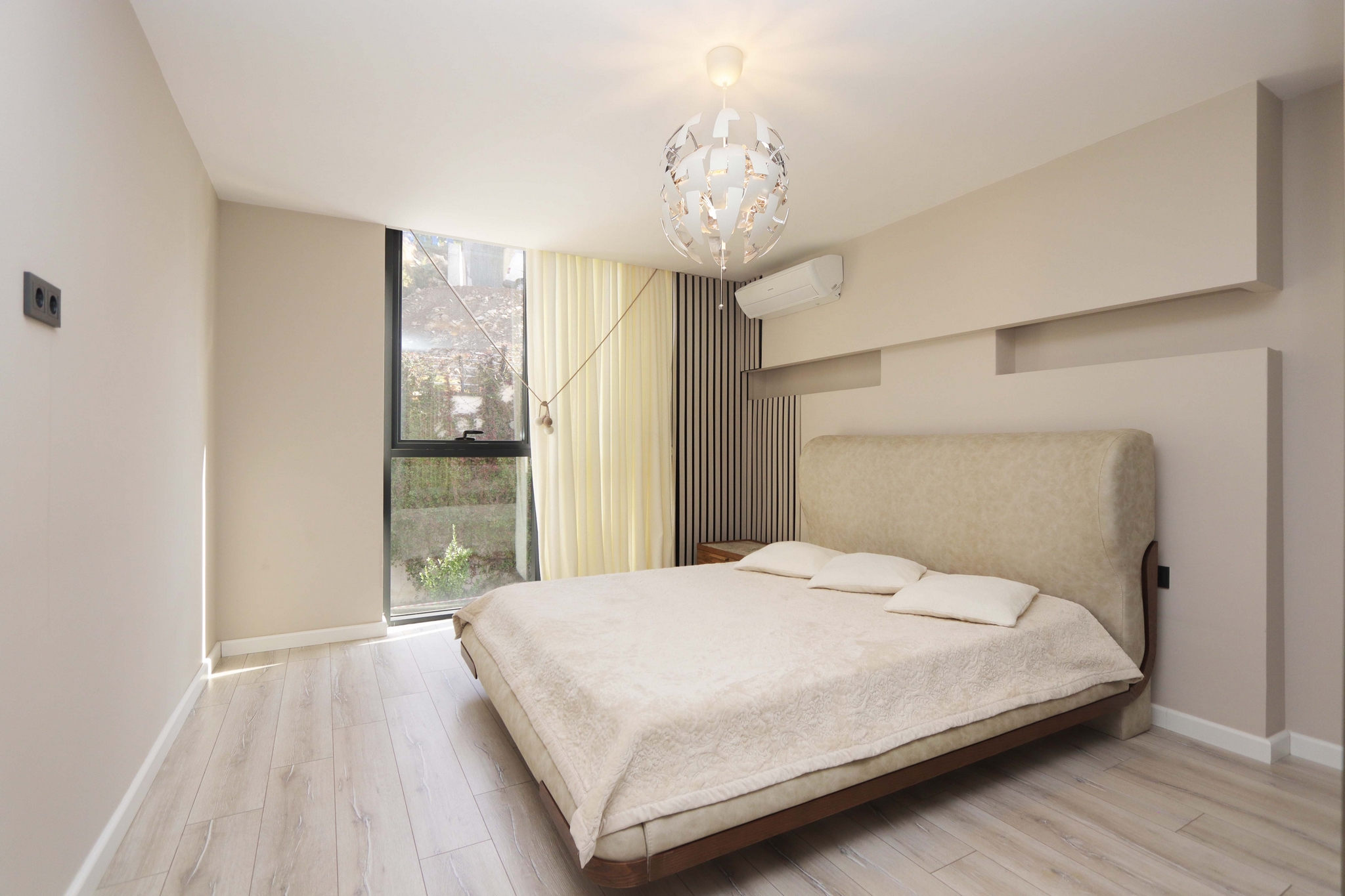 Bedroom with a double bed, upholstered headboard and panoramic window in a 2+1 home in Kargicak