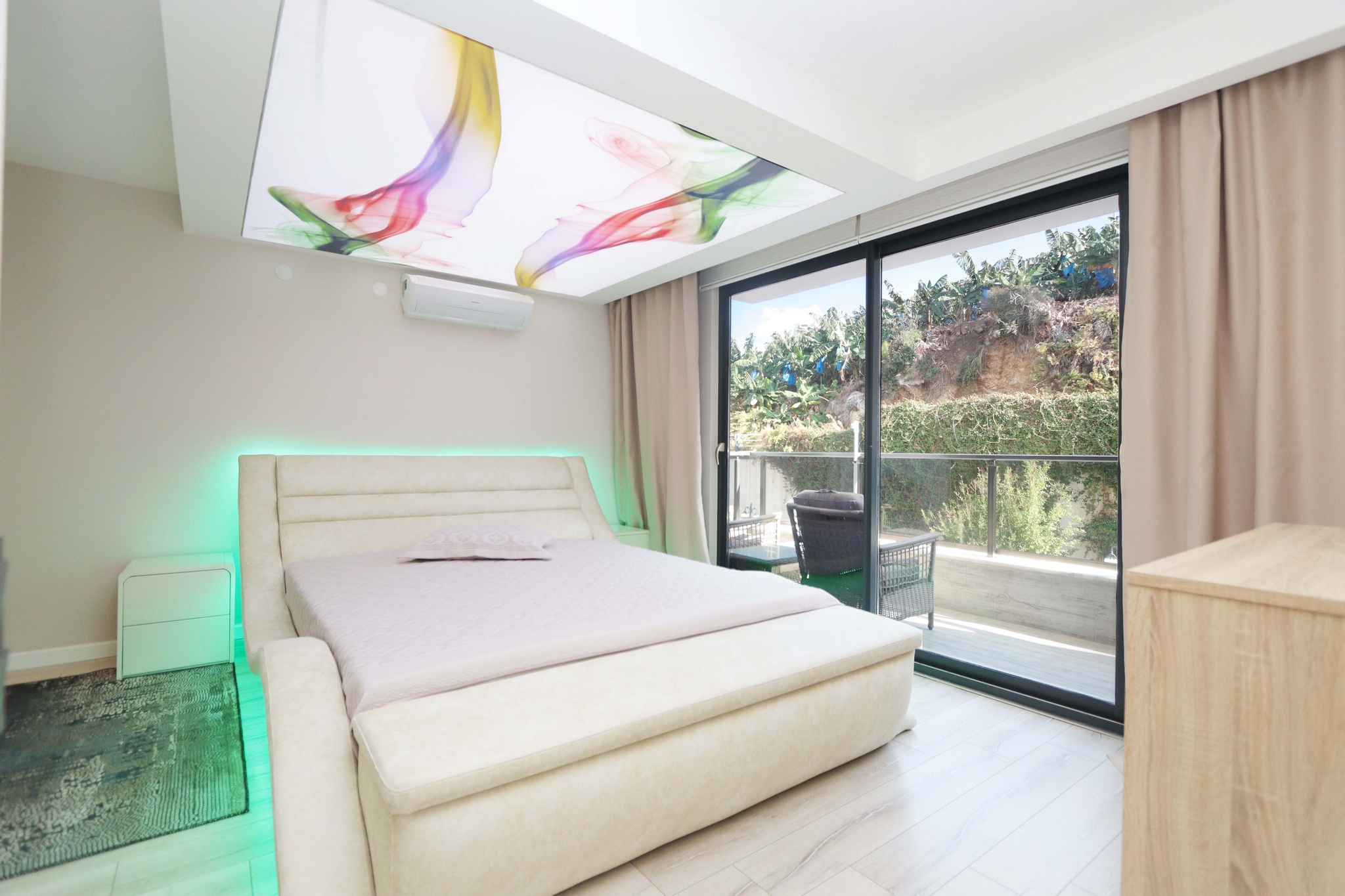 Bedroom with upholstered headboard, balcony access and decorative lighting in Kargicak