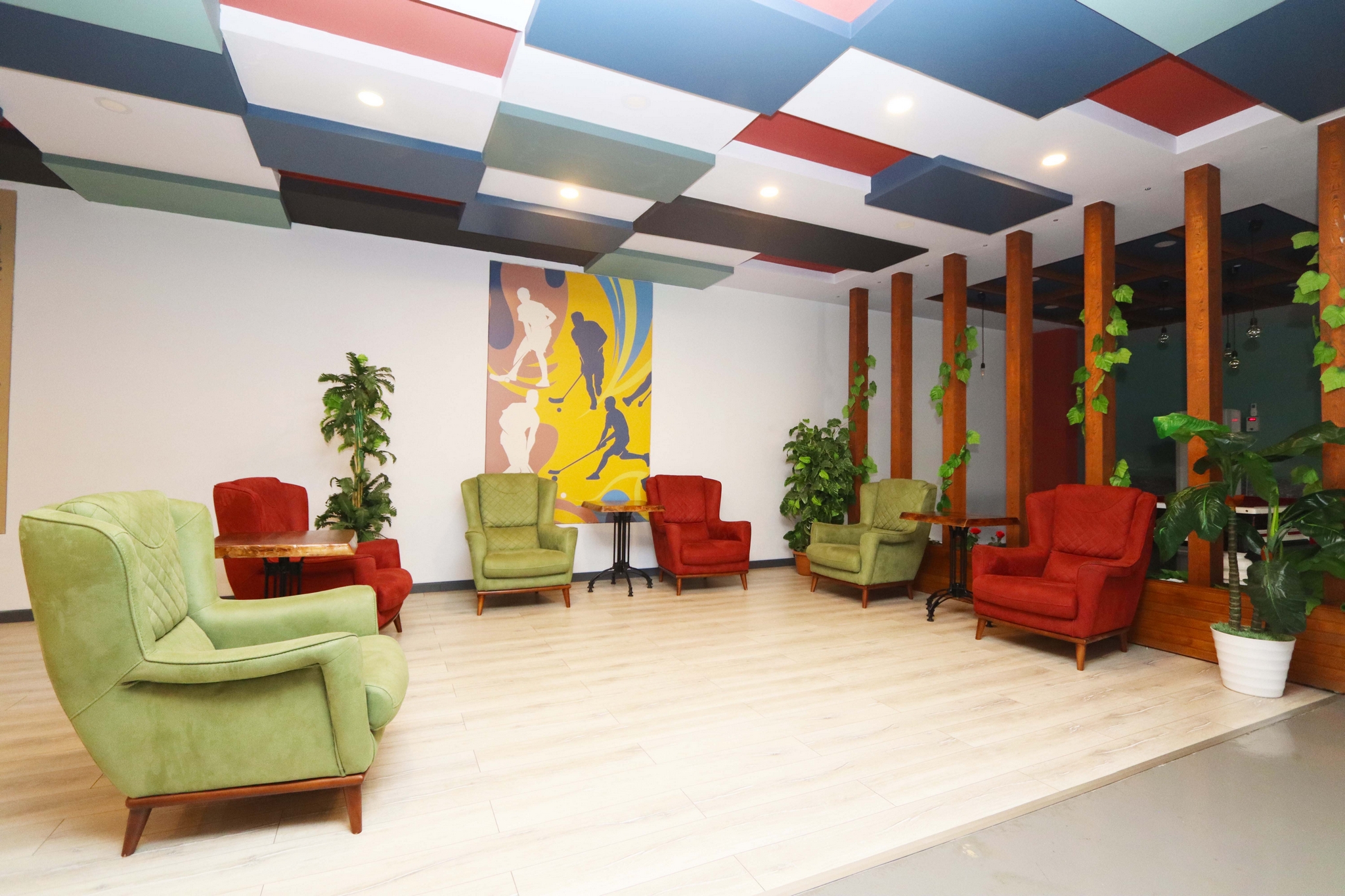 Lobby with colorful armchairs, side tables and decorative partitions beside residences in Kargicak, Turkey
