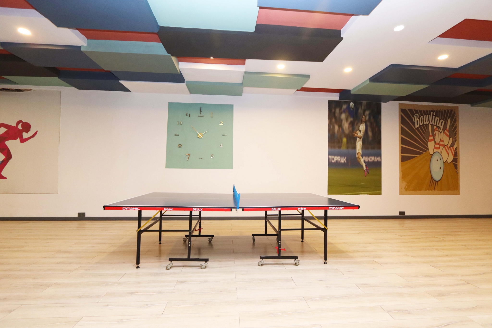 Table tennis table on a light wooden floor with sports posters in a complex in Kargicak