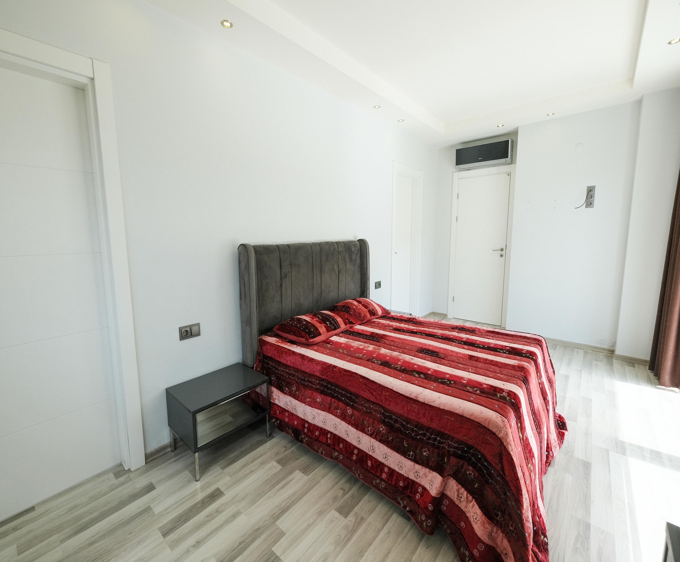 Bedroom with a double bed and grey headboard in a 3+1 apartment in Kargicak