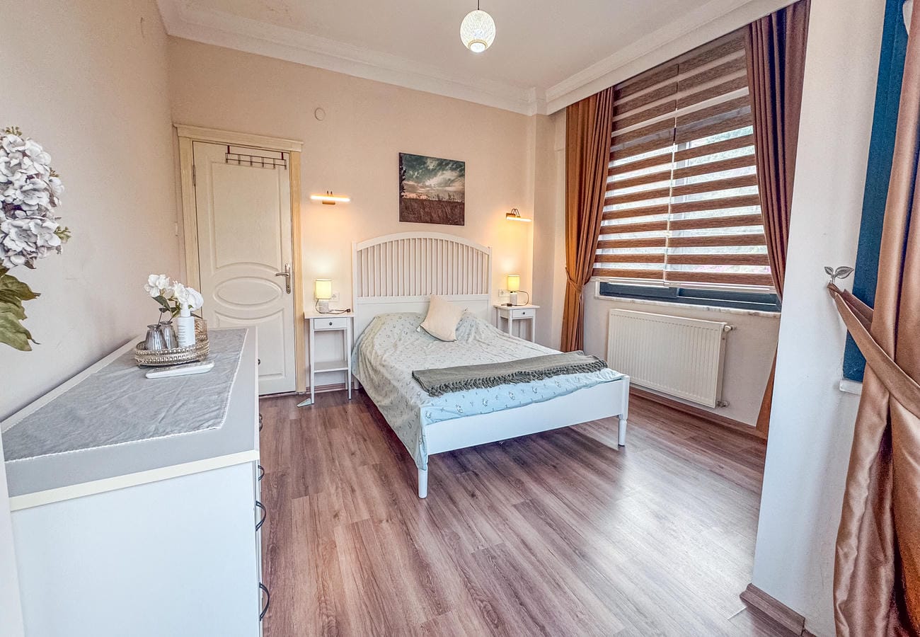 Bedroom with a double bed, bedside tables and a white chest in an apartment in Alanya