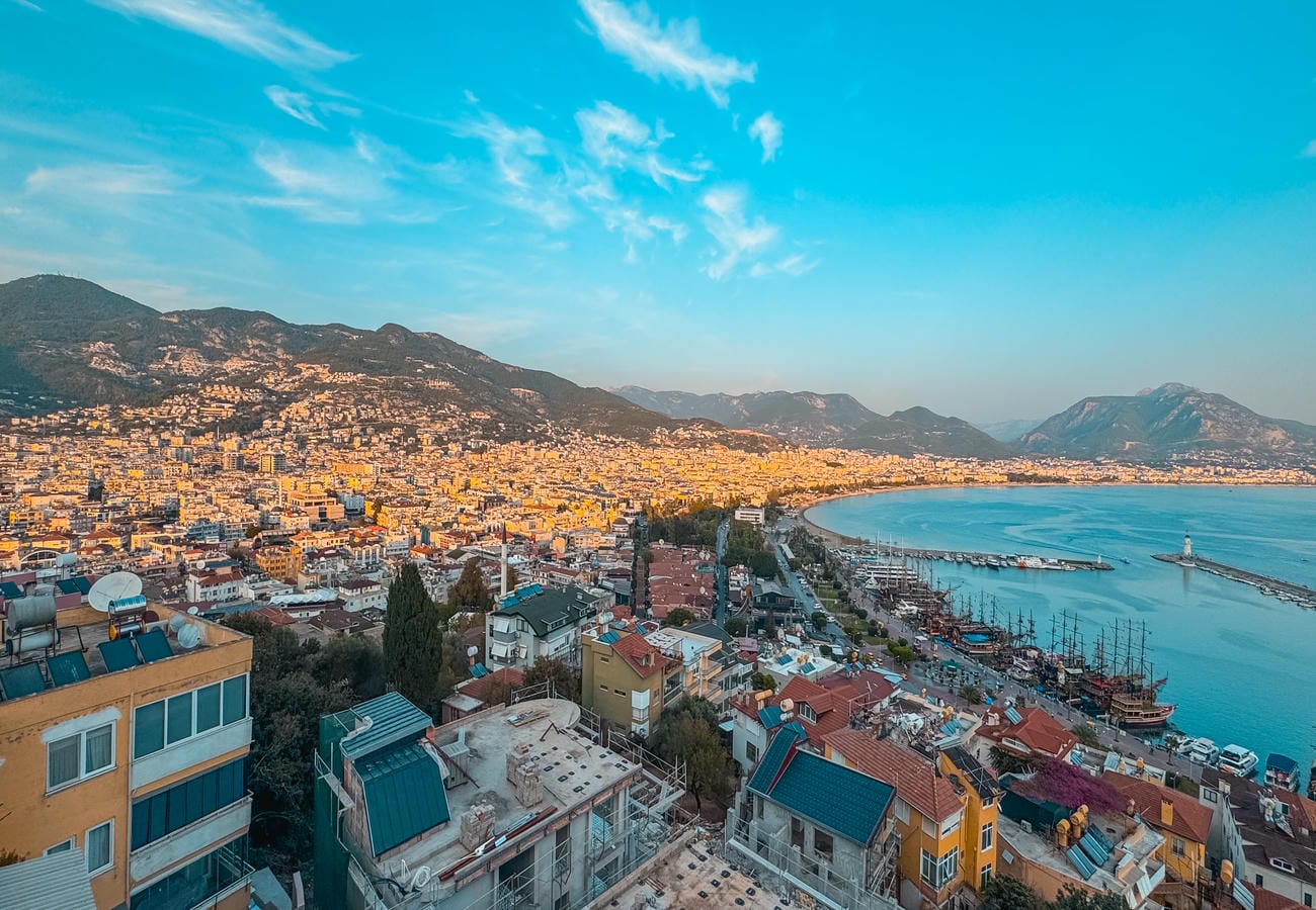 Sea bay with harbor, boats and hillside homes presents apartments for sale
