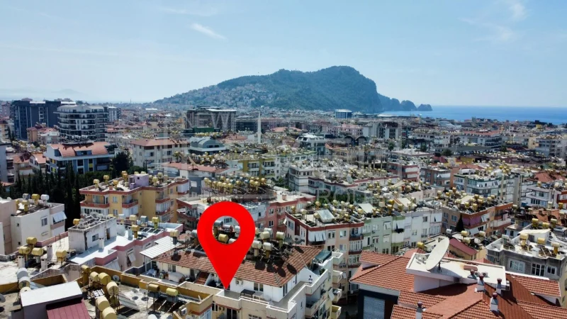 City buildings, mountains and sea to the right frame a 4+1 penthouse for sale in Alanya, Turkey — New Level Group