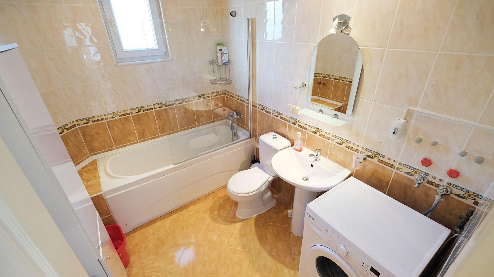 Bathroom in a villa in Mahmutlar with acrylic tub, washing machine and small window