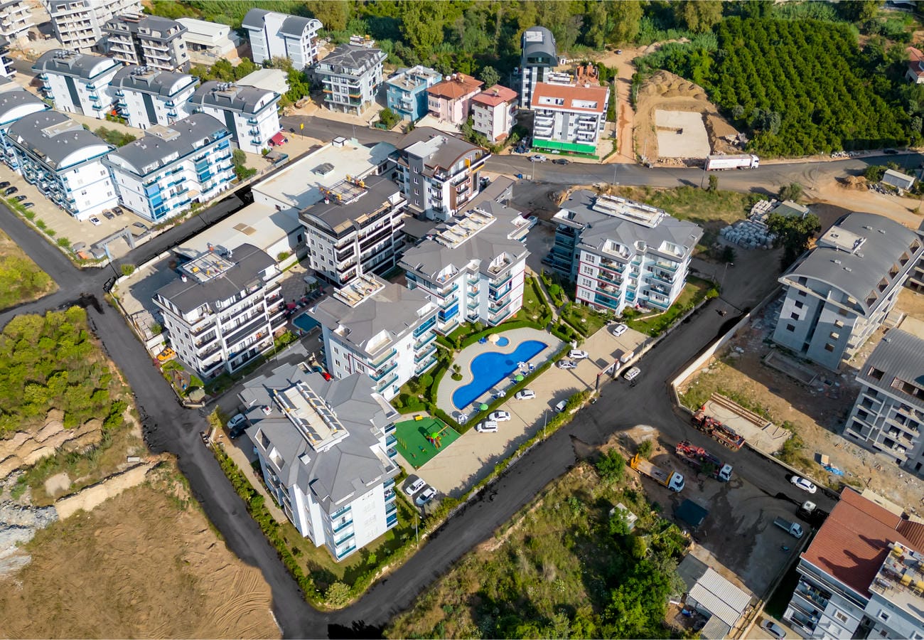 Karma formlu havuz ve yeşil zeminli çocuk alanıyla Oba’da, Türkiye’deki konut sitesi