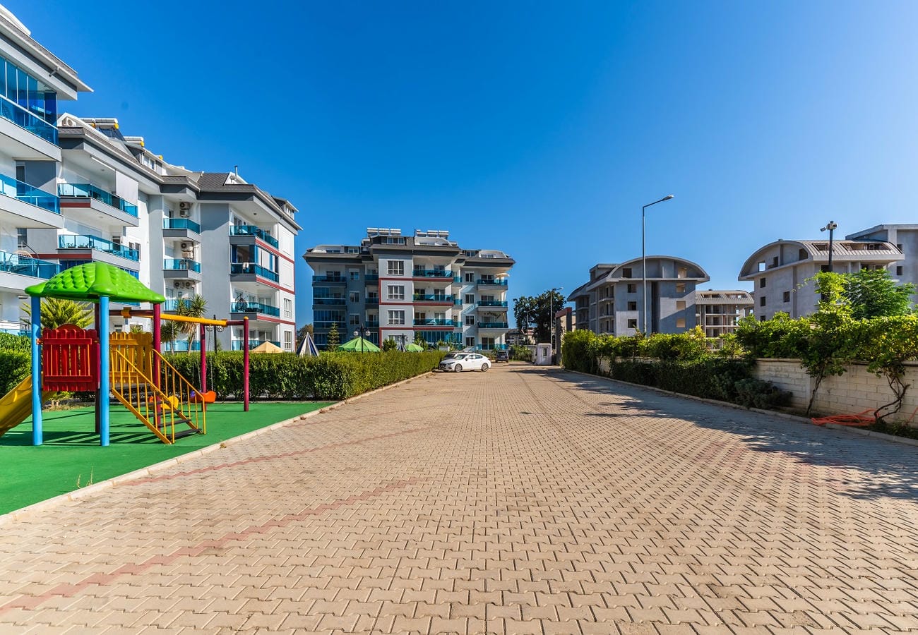 Geniş taş döşeli araç yolu ve çocuk kaydıraklı avlu, Türkiye’de satılık dairelerin bulunduğu sitede