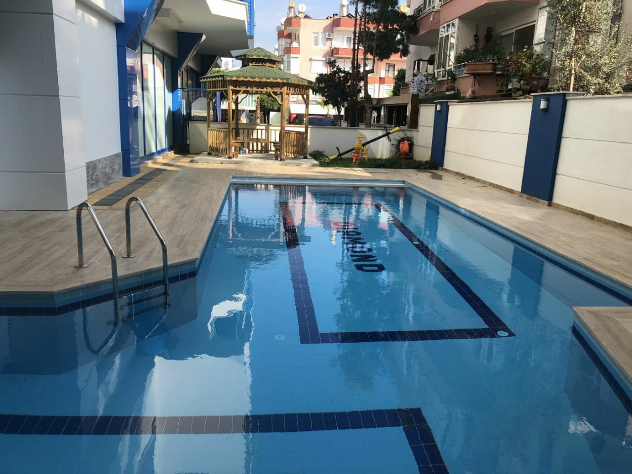 Çardak ve çocuk kaydıraklı havuz, Türkiye’nin Alanya kentindeki rezidans alanında