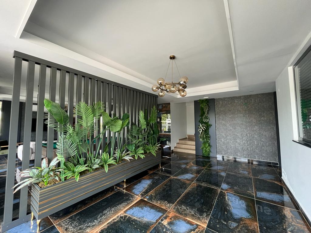 Lobby with glossy black tile flooring and a slatted partition in a complex with apartments in Alanya
