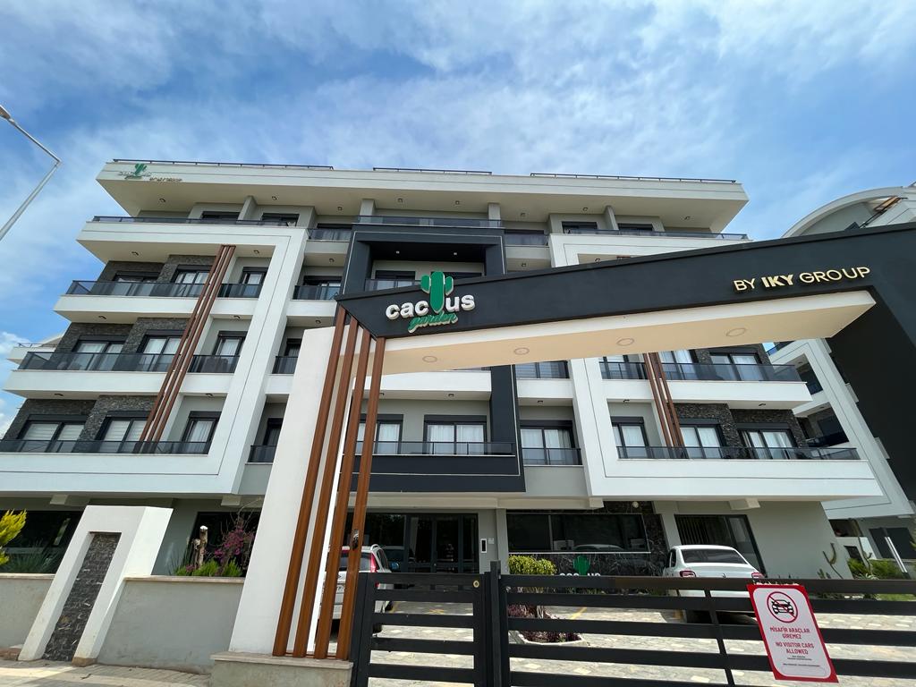 Entrance arch with black gates at a residence in Alanya, Turkey, below a five-story balcony facade