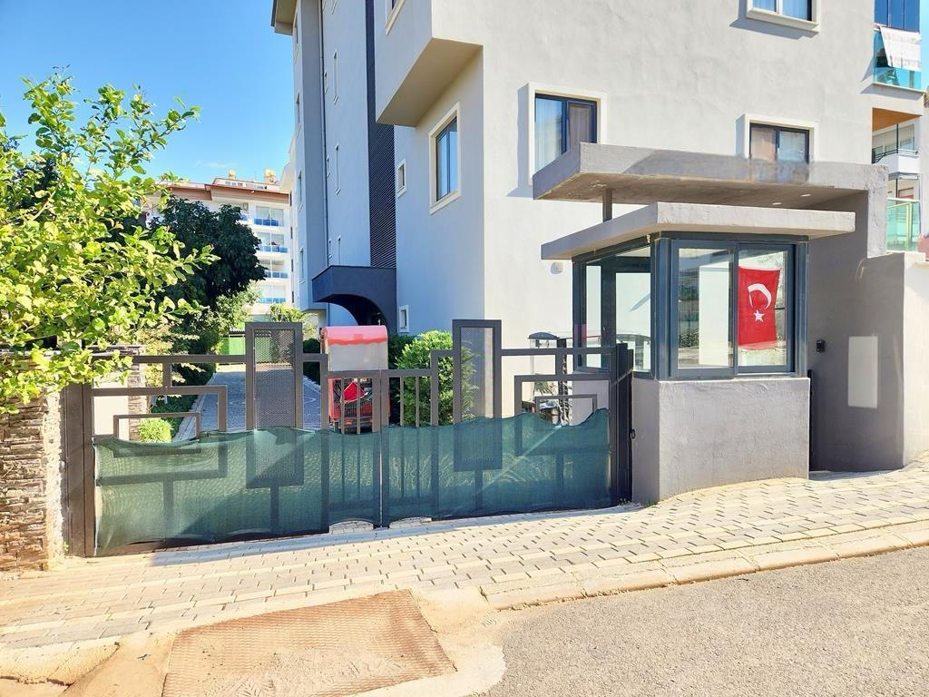Gated residential entrance with a guard booth at a complex with penthouses for sale