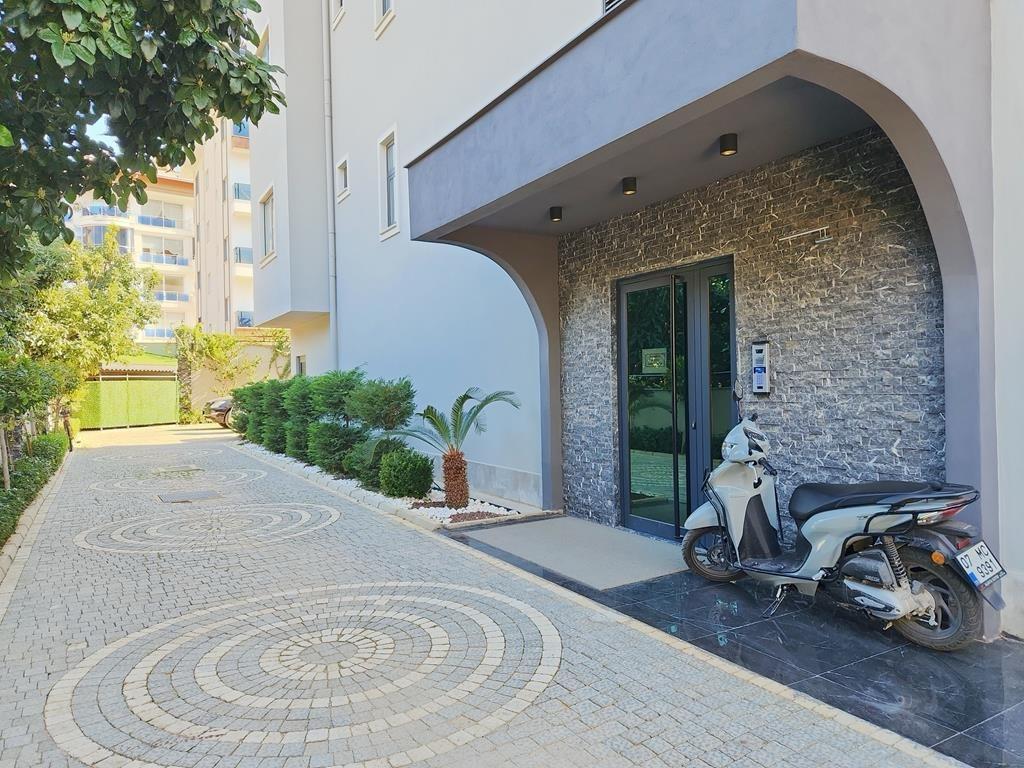 Stone-clad entrance with an arched canopy leading to penthouses in Oba, Alanya