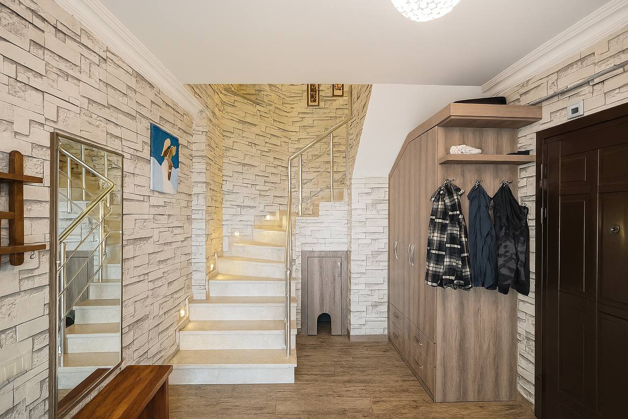 Walk-in wardrobe with a staircase and built-in clothing cabinet in a penthouse