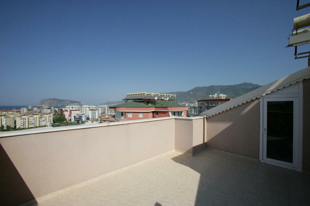 Spacious terrace with a parapet overlooking the city, bay and mountain slope