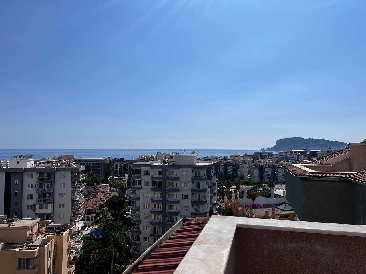 Panoramic sea view from an upper terrace over the city where homes are for sale