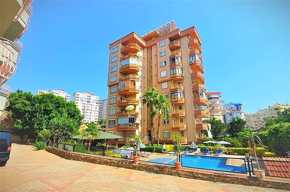Pool and orange-fronted residential tower: 4+1 penthouse for sale in Tosmur, Alanya, Turkey — New Level Group