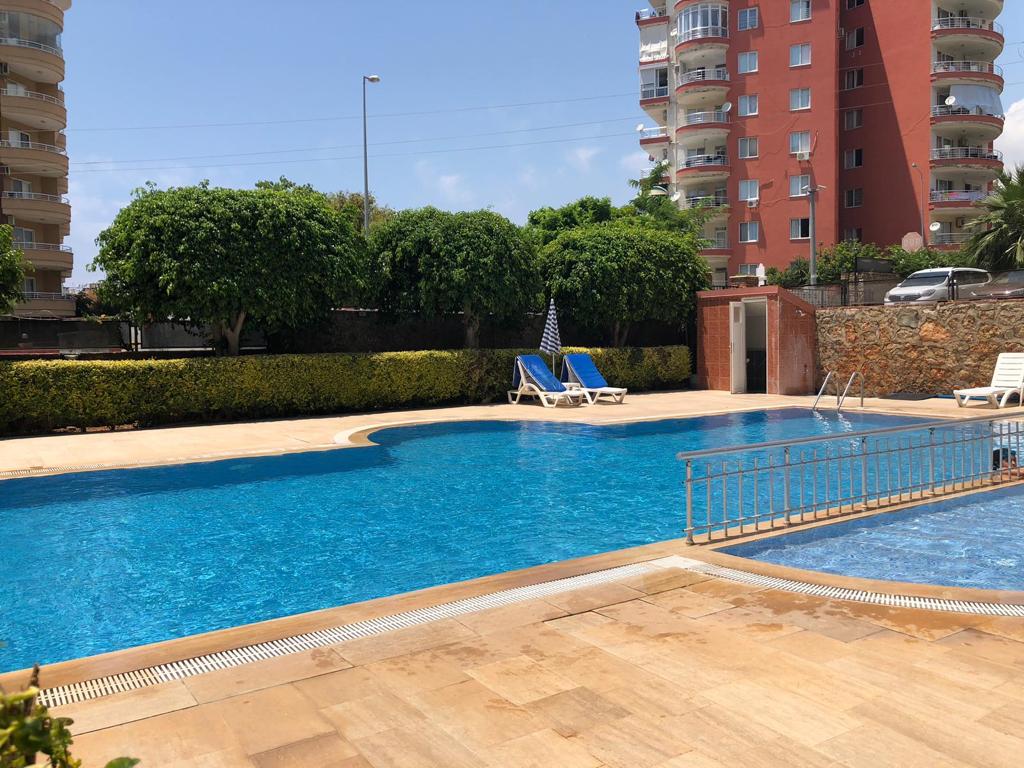 Shallow pool area with loungers in Tosmur where residences are for sale